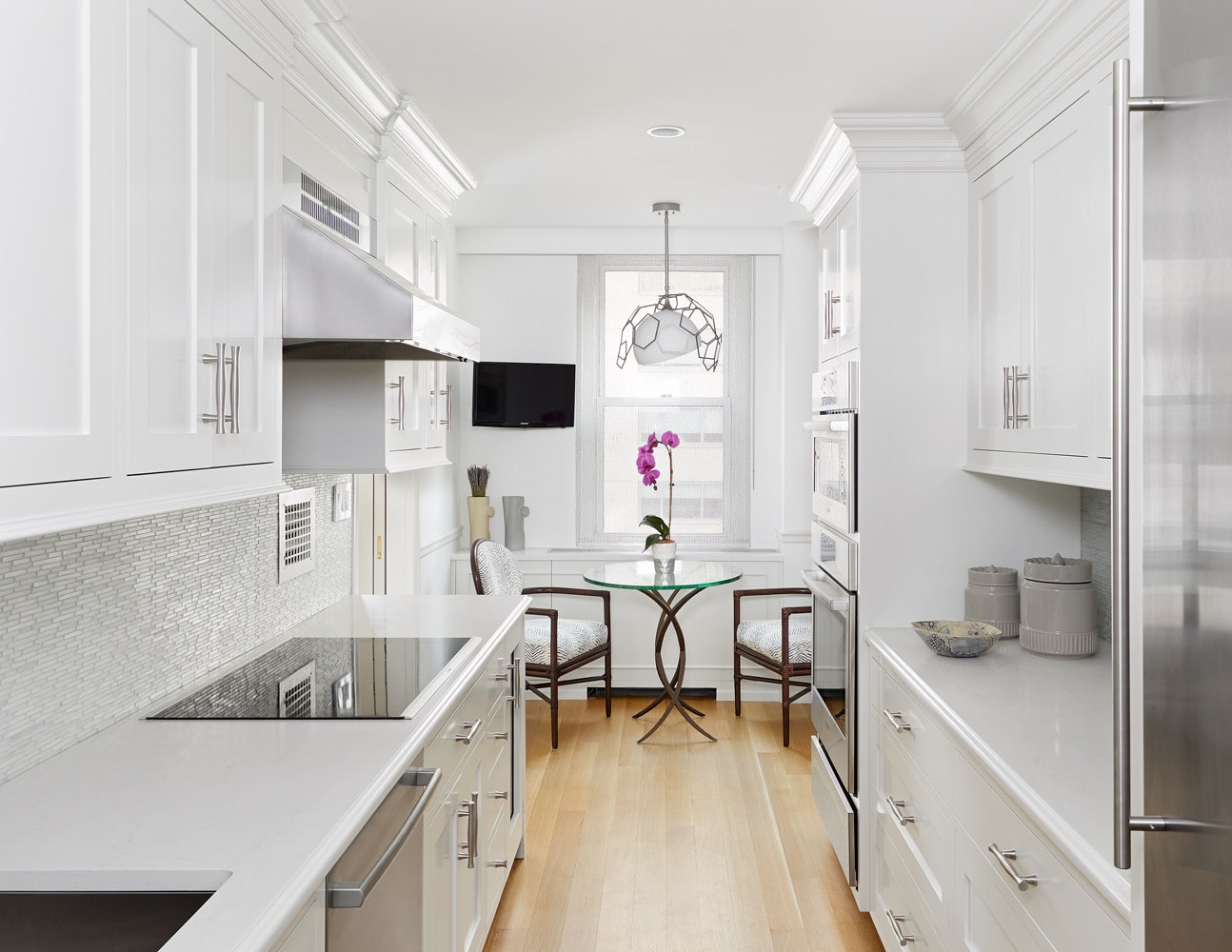 White kitchen and breakfast nook design in an Upper East Side apartment