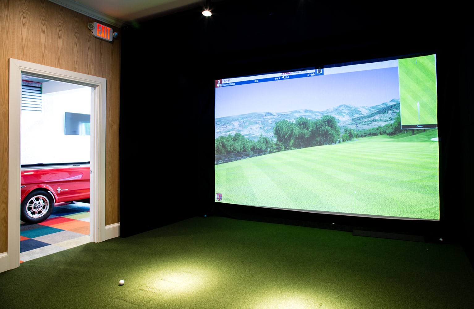 Golf simulator in Residences at Stevens Pond designed by Annette Jaffe Interiors