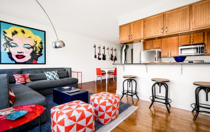 Living room and kitchen with upgraded hardwood floors in Venice Lofts